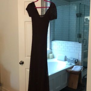 Brown crochet evening gown worn.